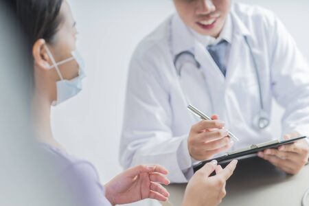 Doctors and patient talking about therapy. Asian peopleの写真素材