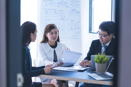 Group of business people busy discussing financial matter during meeting. Asian peopleの写真素材