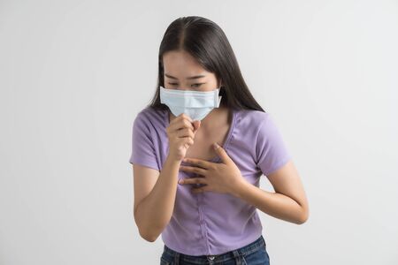 Close up portrait of young woman with medicine health care mask against white white background. CoronaVirus, Covid-19. Asian peopleの写真素材