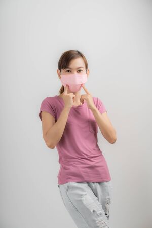 Close up portrait of young woman with medicine health care mask against white white background. CoronaVirus, Covid-19. Asian peopleの写真素材