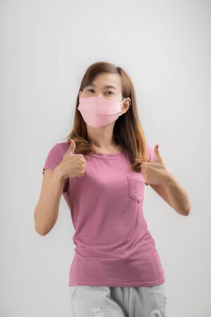 Close up portrait of young woman with medicine health care mask against white white background. CoronaVirus, Covid-19. Asian peopleの写真素材