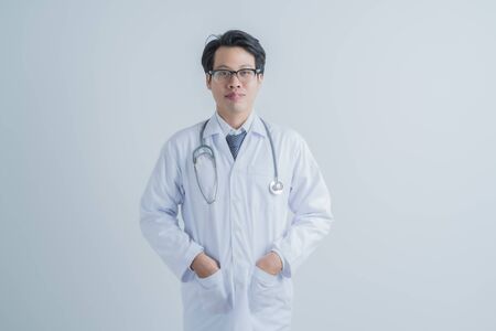 healthcare and medical concept - young male doctor with stethoscope. Asian male modelの写真素材
