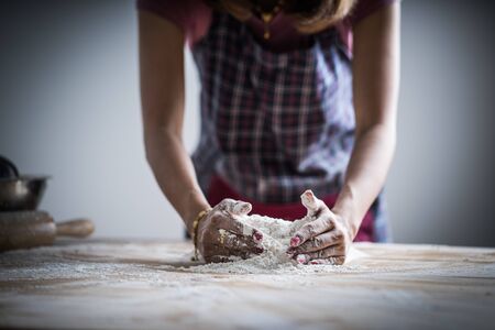 Making dough by female hands at bakeryの写真素材