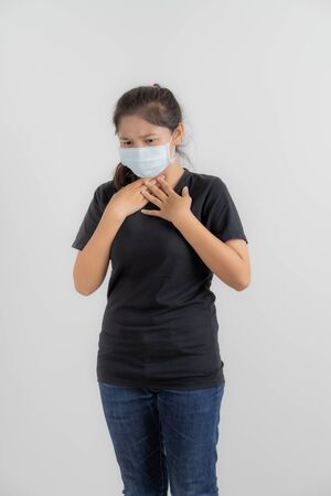 Close up portrait of young woman with medicine health care mask against white white background. CoronaVirus, Covid-19. Asian peopleの写真素材