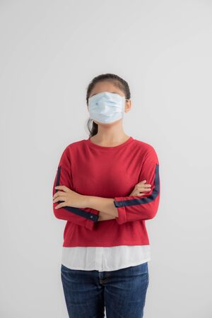Close up portrait of young woman with medicine health care mask against white white background. CoronaVirus, Covid-19. Asian peopleの写真素材