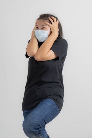 Close up portrait of young woman with medicine health care mask against white white background. CoronaVirus, Covid-19. Asian peopleの写真素材