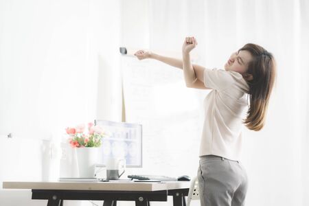 Business woman with back pain in office. Asian people. Work at home conceptの写真素材