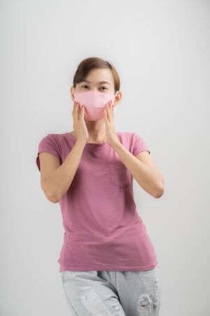 Close up portrait of young woman with medicine health care mask against white white background. CoronaVirus, Covid-19. Asian peopleの写真素材