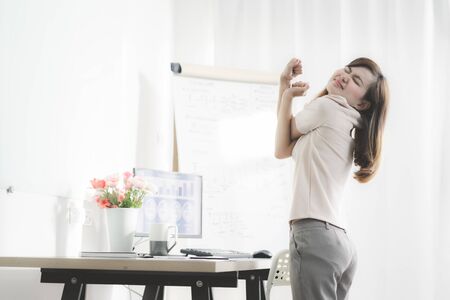 Business woman with back pain in office. Asian people. Work at home conceptの写真素材