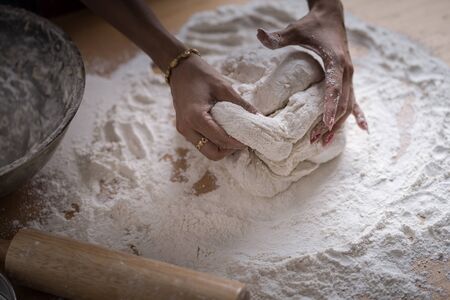 Making dough by female hands at bakeryの写真素材