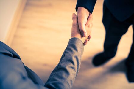 Businessman shaking hands to seal a deal with his partnerの写真素材