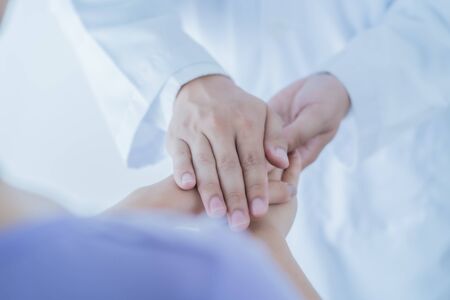 male doctor comforting patient at consulting room. Asian peopleの写真素材