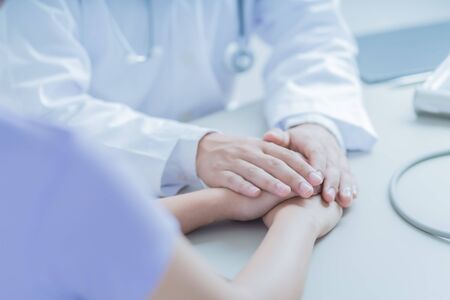 male doctor comforting patient at consulting room. Asian peopleの写真素材