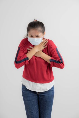 Close up portrait of young woman with medicine health care mask against white white background. CoronaVirus, Covid-19. Asian peopleの写真素材