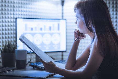 Asian business woman reviewing data in financial charts and graphs. Accountingの写真素材
