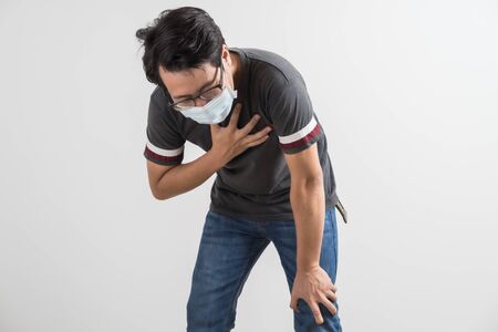 Portrait of young man with medicine health care mask against white gray background. Asian peopleの写真素材