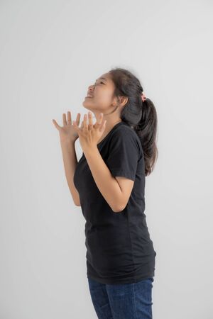 Do not miss. Young asian woman shouting. Shout. Crying emotional woman screaming on pink studio background. Female half-length portrait. Human emotions, facial expression concept. Trendy. Asian peopleの写真素材