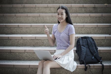 College asian student female sitting on staircase. Asian Peopleの写真素材