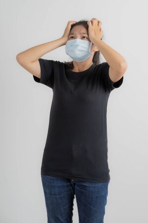 Close up portrait of young woman with medicine health care mask against white white background. CoronaVirus, Covid-19. Asian peopleの写真素材