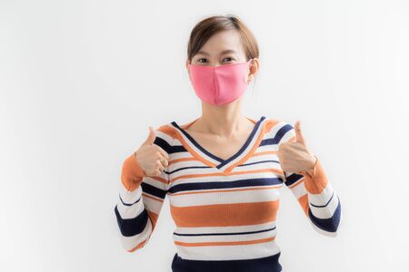 Close up portrait of young woman with medicine health care mask against white white background. CoronaVirus, Covid-19. Asian peopleの写真素材