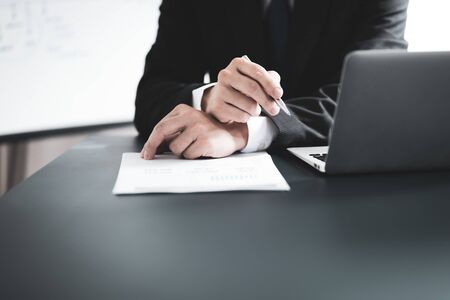 Businessman analyzing investment charts with laptop. Accounting conceptの写真素材
