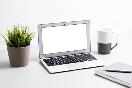 Laptop with blank screen on work table. Home office or work space conceptの写真素材