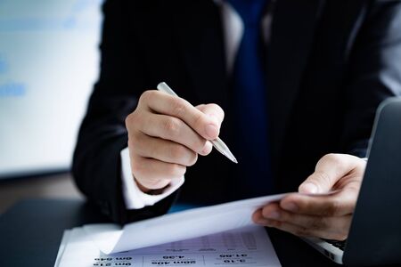 Businessman analyzing investment charts with laptop. Accounting conceptの写真素材