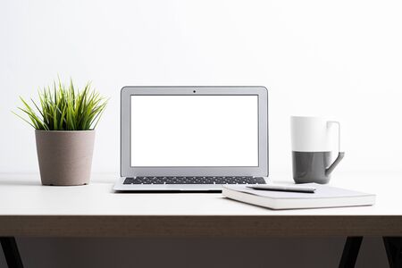 Laptop with blank screen on work table. Home office or work space conceptの写真素材