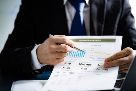 Businessman analyzing investment charts with laptop. Accounting conceptの写真素材