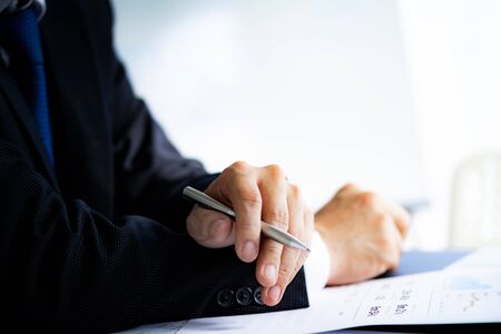Businessman analyzing investment charts with laptop. Accounting conceptの写真素材