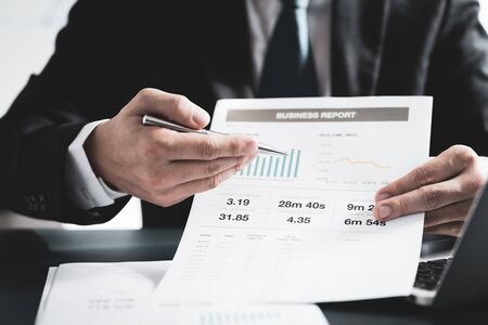 Businessman analyzing investment charts with laptop. Accounting conceptの写真素材
