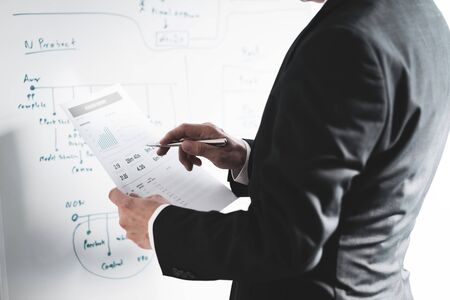 Businessman analyzing investment charts with laptop. Accounting conceptの写真素材