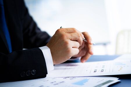 Businessman analyzing investment charts with laptop. Accounting conceptの写真素材