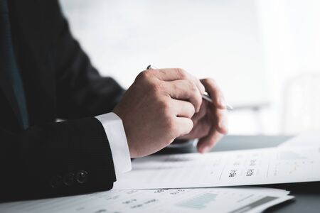 Businessman analyzing investment charts with laptop. Accounting conceptの写真素材