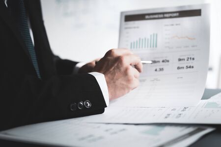 Businessman analyzing investment charts with laptop. Accounting conceptの写真素材