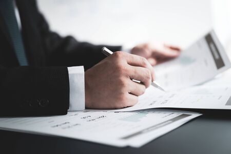 Businessman analyzing investment charts with laptop. Accounting conceptの写真素材