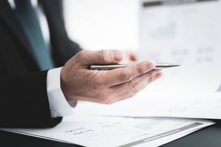 Businessman analyzing investment charts with laptop. Accounting conceptの写真素材