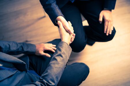 Businessman shaking hands to seal a deal with his partnerの写真素材