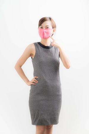 Close up portrait of young woman with medicine health care mask against white whiteの写真素材