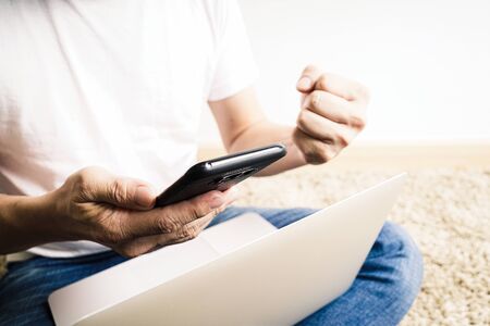 Man using laptop On the floor. Work from home conceptの写真素材