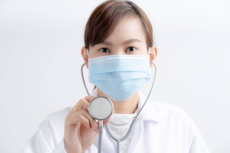 Doctor woman wearing protection face mask against coronavirus.の写真素材