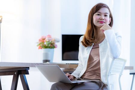 Young woman working at home or in a small office. Asian Peopleの写真素材