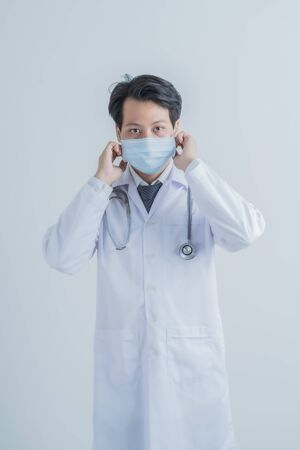 Doctor wearing protection face mask against coronavirus.Asian peopleの写真素材