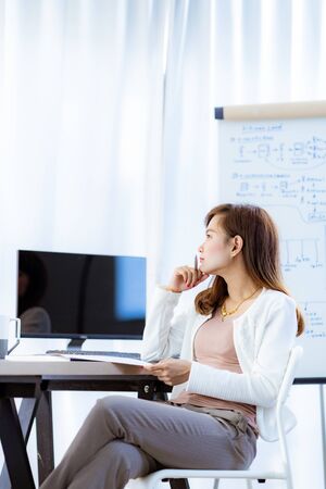 Young woman working at home or in a small office. Asian Peopleの写真素材
