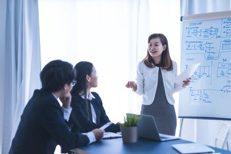 Group of business people busy discussing financial matter during meeting. Asian peopleの写真素材
