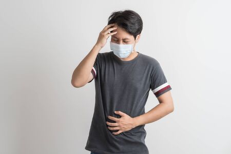 Portrait of young man with medicine health care mask against white gray background. Asian peopleの写真素材