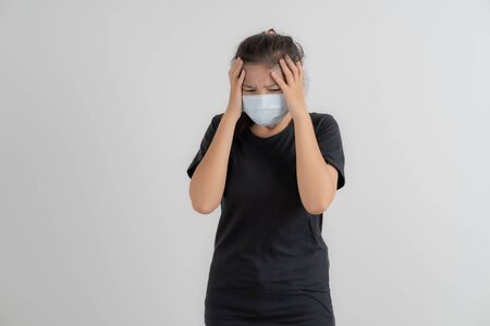 Close up portrait of young woman with medicine health care mask against white white background. CoronaVirus, Covid-19. Asian peopleの写真素材
