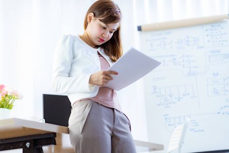 Young woman working at home or in a small office. Asian Peopleの写真素材