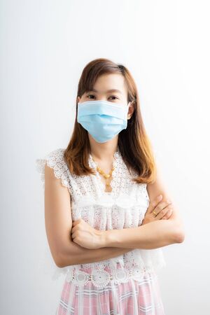 Close up portrait of young woman with medicine health care mask against white white background. CoronaVirus, Covid-19. Asian peopleの写真素材