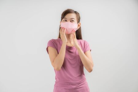 Close up portrait of young woman with medicine health care mask against white white background. CoronaVirus, Covid-19. Asian peopleの写真素材